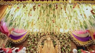 A tilt view of the Sai Ram or Sai Baba idol amidst floral decoration during the religious event