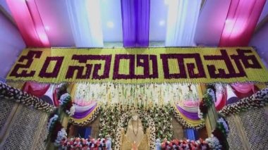 A tilt view of the Sai Ram or Sai Baba idol amidst floral decoration during the religious event