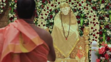 Closeup video of the Sai Ram or Sai Baba idol being worshipped with arti during religious event