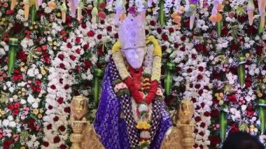 Closeup video of the Sai Ram or Sai Baba idol being worshipped with arti during religious event