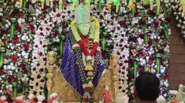 Closeup video of the Sai Ram or Sai Baba idol being worshipped with arti during religious event