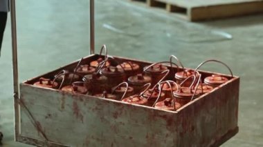 A view of liquid essence containers being moved in a small trolly inside the soap factory