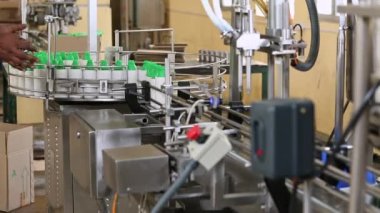 A view of coconut oil being filled into the bottles inside the factory during the production