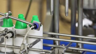 Closeup of coconut oil being filled into the bottles inside the factory during the production