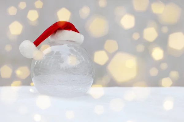 Transparent Glass Ball Snow Christmas Hat Snow Bokeh Flare Santa — Stock Photo, Image