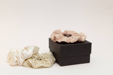 gift box with beige silk scrunchies. lot or hair ties. Luxury tools for ladies. perfect for all hair types. elastic hair tie accessories.