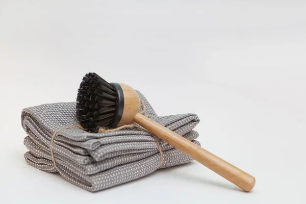 dish wash bamboo scrub brush and gray towels. Sustainable lifestyle zero waste concept. Clean without waste. No plastic objects.