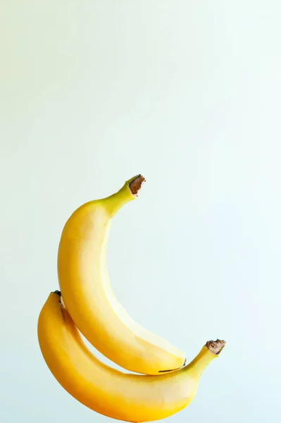 two sexy bananas touching each other. happy yelow Banana fruits levitation on white background