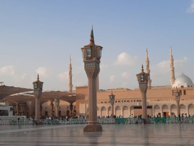 Beautiful daytime view of Masjid Al Nabawi, Medina's minarets and mosque courtyard.