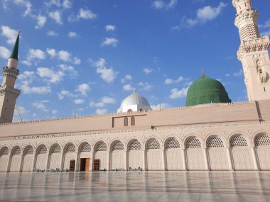 Beautiful daytime view of Masjid Al Nabawi, Medina's minarets and mosque courtyard.