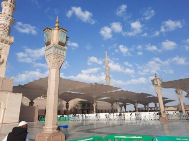 Beautiful daytime view of Masjid Al Nabawi, Medina's minarets and mosque courtyard.