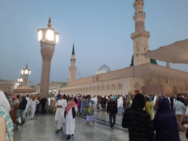 Pilgrims  gather in the evening in the outer courtyard of Masjid Al Nabawi, Madinah.