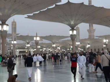 Pilgrims  gather in the evening in the outer courtyard of Masjid Al Nabawi, Madinah.