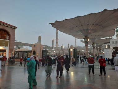 Pilgrims  gather in the evening in the outer courtyard of Masjid Al Nabawi, Madinah.