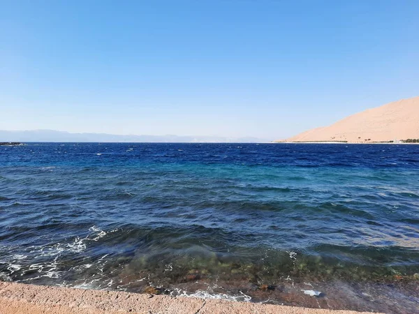 The mesmerizing view of the deep blue waters of Haql beach in Saudi Arabia.