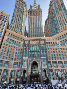 A beautiful daytime view of the Mecca Clock Tower in front of the Grand Mosque in Mecca, Saudi Arabia.