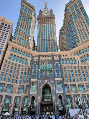 A beautiful daytime view of the Mecca Clock Tower in front of the Grand Mosque in Mecca, Saudi Arabia.
