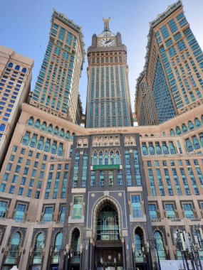 A beautiful daytime view of the Mecca Clock Tower in front of the Grand Mosque in Mecca, Saudi Arabia.