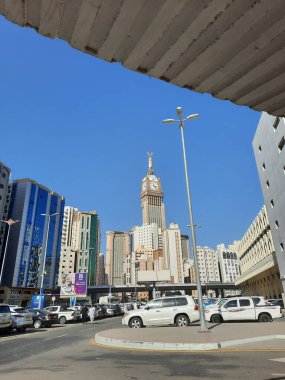 A beautiful daytime view of the Mecca Clock Tower in front of the Grand Mosque in Mecca, Saudi Arabia.