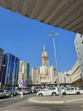 A beautiful daytime view of the Mecca Clock Tower in front of the Grand Mosque in Mecca, Saudi Arabia.