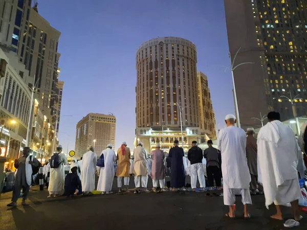 stock image Pilgrims from around the world pray at night on the road outside Masjid al-Haram, Mecca.