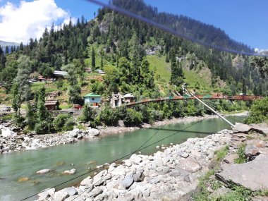 Kaşmir 'deki Neelum Vadisi' nin göz kamaştırıcı gündüz manzarası. Kaşmir 'deki Neelum Vadisi nefes kesici bir yerdir. Bereketli yeşil manzarası, uzun ağaçları ve canlı yeşilliği cennete benzer bir manzara yaratır..