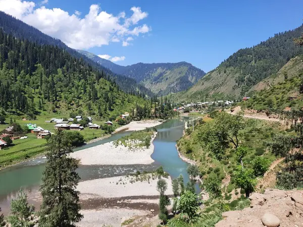 Kaşmir 'deki Neelum Vadisi' nin göz kamaştırıcı gündüz manzarası. Kaşmir 'deki Neelum Vadisi nefes kesici bir yerdir. Bereketli yeşil manzarası, uzun ağaçları ve canlı yeşilliği cennete benzer bir manzara yaratır..