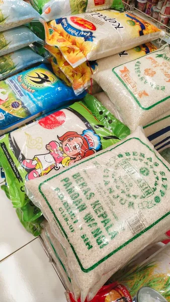 Bandung, Endonezya-2 Ekim 2023; Bir süpermarkette, birçok çeşit pirinç paketleri depolanmak için yığılır