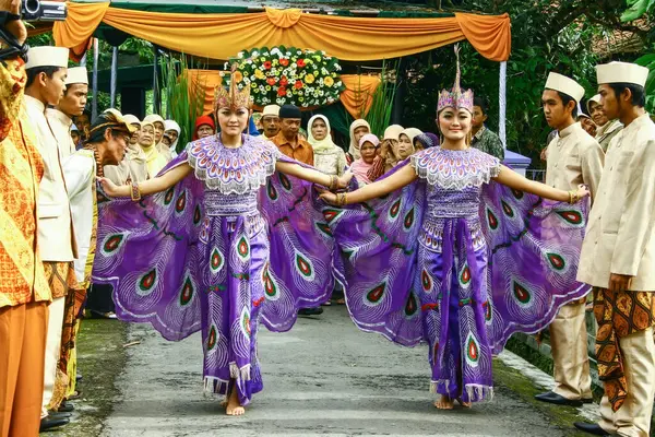 Sumedang, Indonesia - March 13th 2011: Peacock Dance (lengser). at a traditional Sundanese wedding ceremony. Peacock Dance is a type of dance that depicts and symbolizes the movements of a peacock