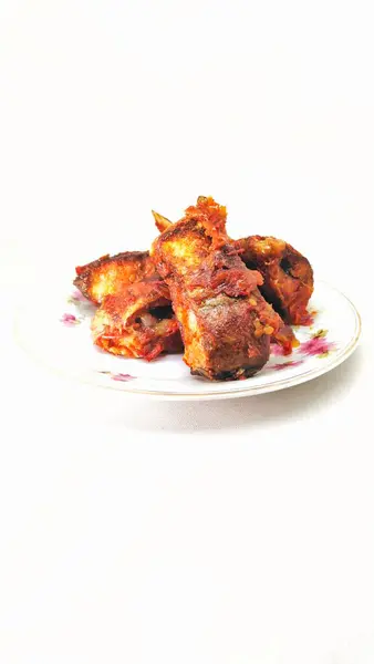 Balado Tuna Fish dish on a white background. This Padang-style dish is very popular because of its delicious spicy taste