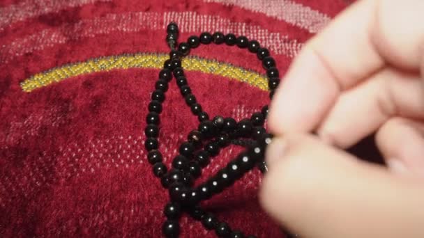 黒い祈りのビーズを使用した祈りのマット上のダリットの活動の閉鎖 — ストック動画