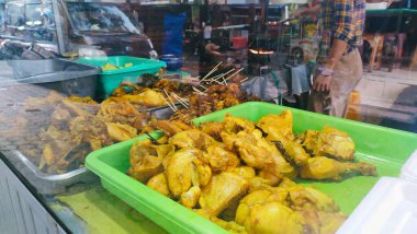 a choice of chicken cuts sold by fried chicken sellers, ready to be cooked to order. There are also chicken offal satay, chicken skin satay, tofu and tempeh clipart