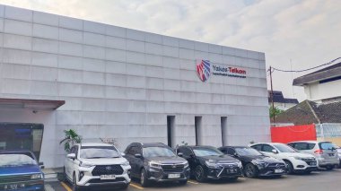 Bandung, Indonesia - May 20th 2024; car parking area in front of the Health Foundation building of the Telkom company