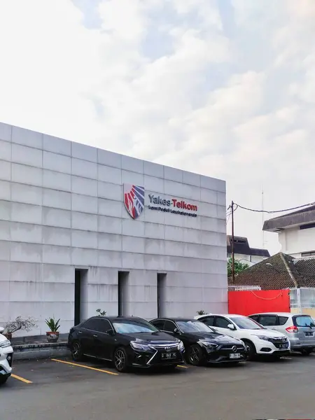 stock image Bandung, Indonesia - May 20th 2024; car parking area in front of the Health Foundation building of the Telkom company