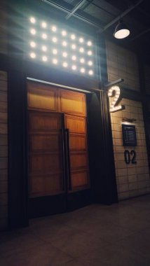 interior of the entrance to studio 2 with closed wooden doors in a cinema building clipart