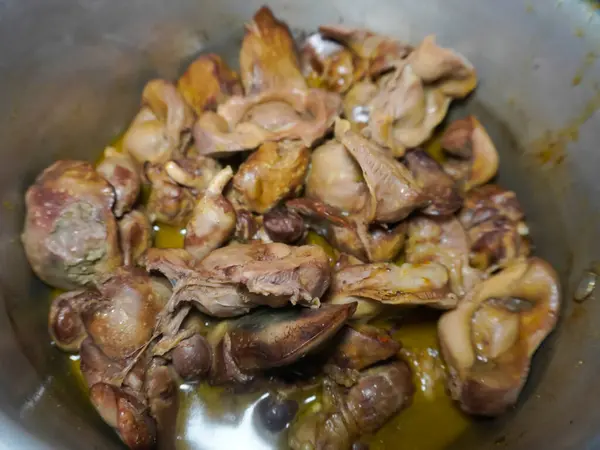 stock image half-cooked chicken liver and gizzards in a pan, in preparation for cooking