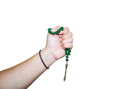 person's hand holding a green agate stone prayer beads tasbih isolated on white background  clipart