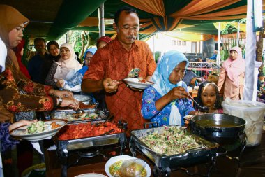Sumedang, Endonezya - 13 Mart 2011; Davet edilen konuklar düğün etkinliğinde sırayla çeşitli büfe menüleri alıyorlar