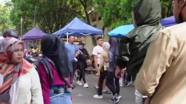 Bandung, Endonezya - 22 Aralık 2024; tatil sabahları toplum aktiviteleri, çeşitli sokak yemekleri alırken egzersiz