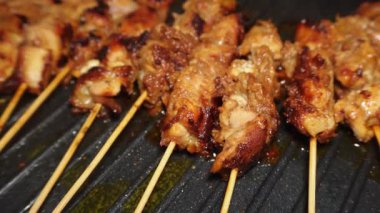 Cooking chicken skewers at home using a non-stick grill pan, homemade recipe