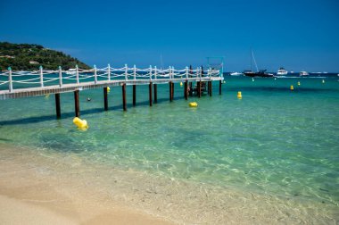 Saint-Tropez yakınlarındaki efsanevi Pampelonne plajındaki yatların misafirleri için ahşap iskele. Fransız Riviera, Fransa 'nın beyaz kumlu sahillerinde yaz tatili.
