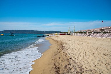 Crystal clear blue water of  legendary Pampelonne beach near Saint-Tropez, summer vacation on white sandy beach of French Riviera, France clipart