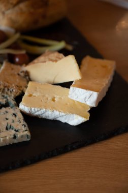 Tasting of fresh farmers scottish cheeses smoked cheddar, stilton, blue cheese, brie in Edinburgh, UK