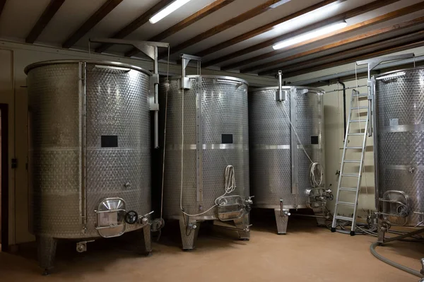 Stages of wine production from fermentation to bottling, visit to wine cellars in Cote d\'Or, Burgundy, France, steel vats for fermentation.