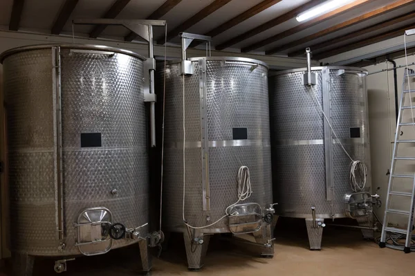 Stages of wine production from fermentation to bottling, visit to wine cellars in Cote d\'Or, Burgundy, France, steel vats for fermentation.