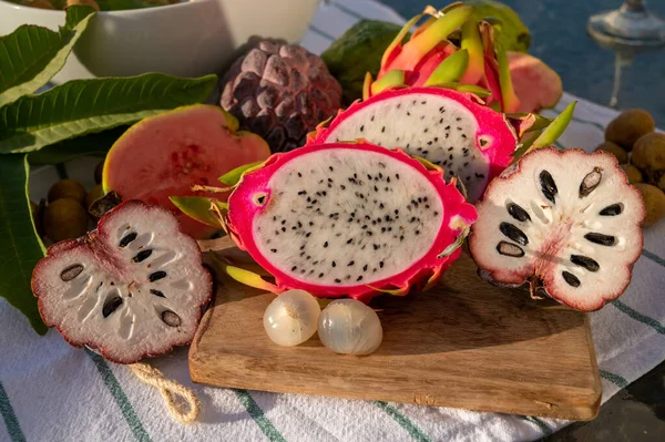 stock image Variaty of tasty tropical exotic fruits, ripe fresh lychee, dragon fruit, guava and cherimoya