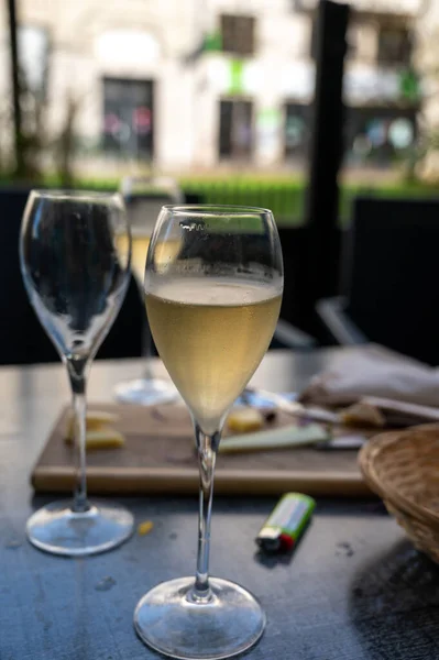 stock image Tasting of white brut sparkling champagne wine outdoor in cafe in Reims, Champagne, France