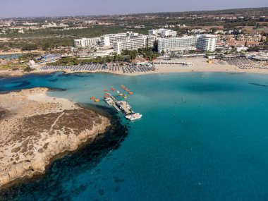 Kıbrıs 'ın Ayia Napa plajı yakınlarındaki Akdeniz' de mavi kristal berrak su üzerindeki hava panoramik manzarası. Deniz tatili.