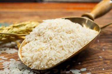 Organik beyaz pişmemiş pirinç ve kurutulmuş Hint basmati pilavı ahşap masaya ekilir.