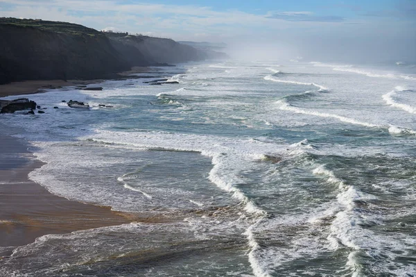 stock image Magoito Beach on Atlantic ocean during storm and high waves, beautiful sandy beach on Sintra coast, Lisbon district, Portugal, part of Sintra-Cascais Natural Park with natural points of interest